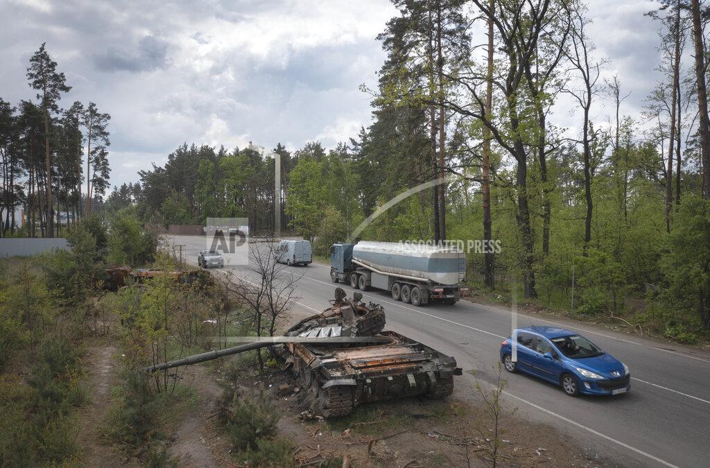 Efrem Lukatsky Cars pass by Russian tanks destroyed in a recent battle against Ukrainians in the village of Dmytrivka, close to Kyiv, Ukraine, Monday, May 23, 2022. (AP Photo/Efrem Lukatsky)