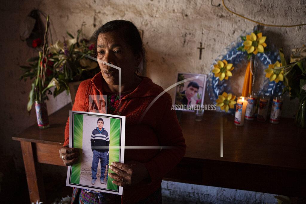 Oliver De Ros Elena Marroquin poses for a portrait holding a photo of her grandson Rivaldo Danilo Jimenez, in her home in Comitancillo, Guatemala, Wednesday, Jan. 27, 2021. She believes that her grandson was one of 19 bodies, shot and burned, found in late January, inside a pickup truck near the Mexico-Texas border. (AP Photo/Oliver de Ros)