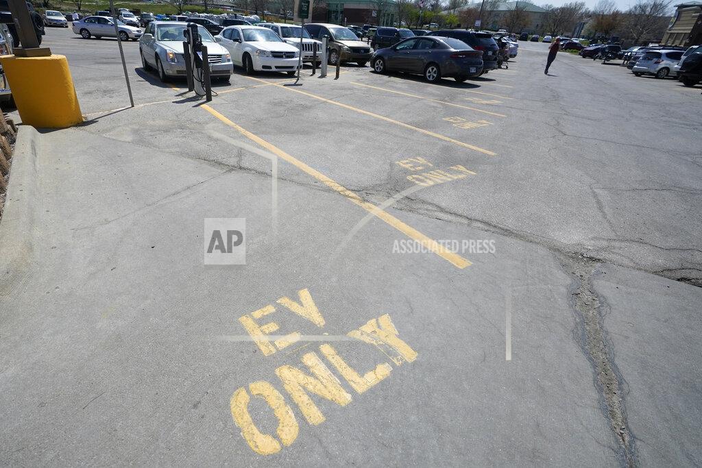 Orlin Wagner Four electric vehicle charging spots stand empty in a grocery story parking lot in Lawrence, Kan., Monday, April 5, 2021. The president and the auto industry maintain the nation is on the cusp of a gigantic shift to electric vehicles and away from liquid-fueled cars, but biofuels producers and some of their supporters in Congress aren’t buying it. They argue the U.S. should increase sales of ethanol and biodiesel, not abandon them. (AP Photo/Orlin Wagner)