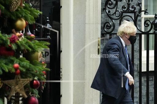 British Prime Minister Boris Johnson walks past a Christmas tree whilst leaving 10 Downing Street to attend the weekly Prime Minister's Questions at the Houses of Parliament, in London, Wednesday, Dec. 1, 2021. (AP Photo/Matt Dunham)