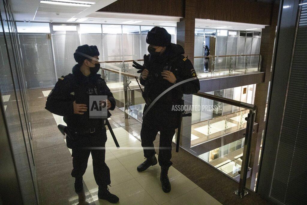 Pavel Golovkin Police stand guard at the Foundation for Fighting Corruption office in Moscow, Russia, Wednesday, Jan. 27, 2021. Police are searching the Moscow apartment of jailed Russian opposition leader Alexei Navalny, another apartment where his wife is living and two offices of his anti-corruption organization. Navalny's aides reported the Wednesday raids on social media. (AP Photo/Pavel Golovkin)