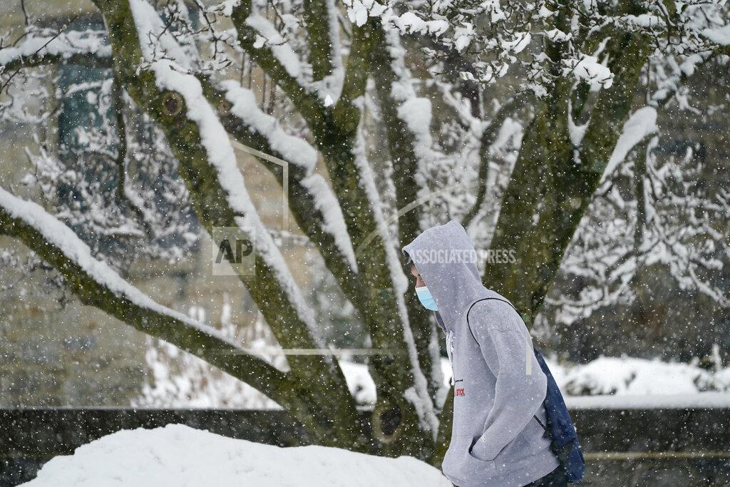 Matt Slocum A man walks through the snow during a winter storm, Sunday, Feb. 7, 2021, in Villanova, Pa. (AP Photo/Matt Slocum)