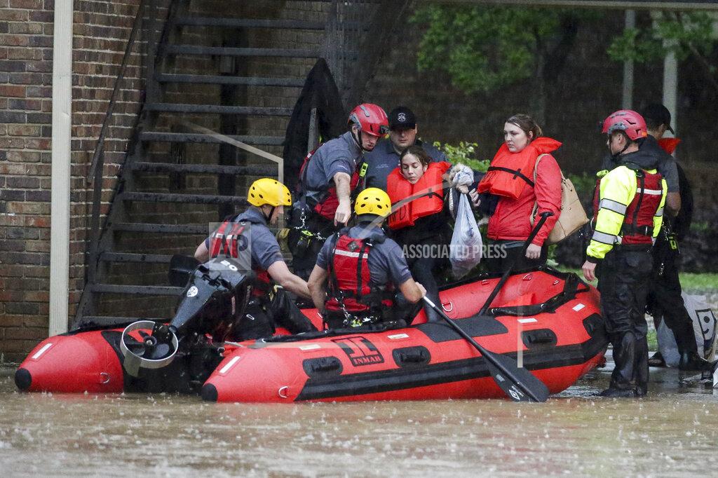 Butch Dill Residents of the Crescent at Lakeshore apartment complex are rescued by Homewood Fire and Rescue as severe weather produced torrential rainfall flooding several apartment buildings Tuesday, May 4, 2021 in Homewood, Ala. (AP Photo/Butch Dill)