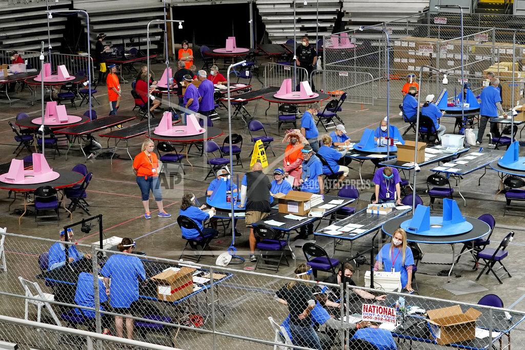 Matt York FILE - In this May 6, 2021 file photo, Maricopa County ballots cast in the 2020 general election are examined and recounted by contractors working for Florida-based company, Cyber Ninjas at Veterans Memorial Coliseum in Phoenix. On Friday, May 21, The Associated Press reported on stories circulating online incorrectly claiming the election database in Maricopa County, in Arizona has been deleted, seals were improperly broken on boxes that hold the votes and ballots are missing.(AP Photo/Matt York, Pool, File)