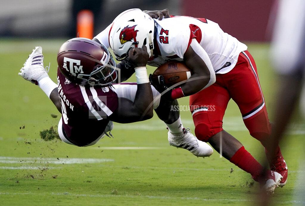Sam Craft Texas A&M defensive lineman Tyree Johnson (3) grabs the facemark of Lamar running back A.J. Walker (27) while tackling him during the first half of an NCAA college football game, Saturday, Sept. 14, 2019, in College Station, Texas. (AP Photo/Sam Craft)