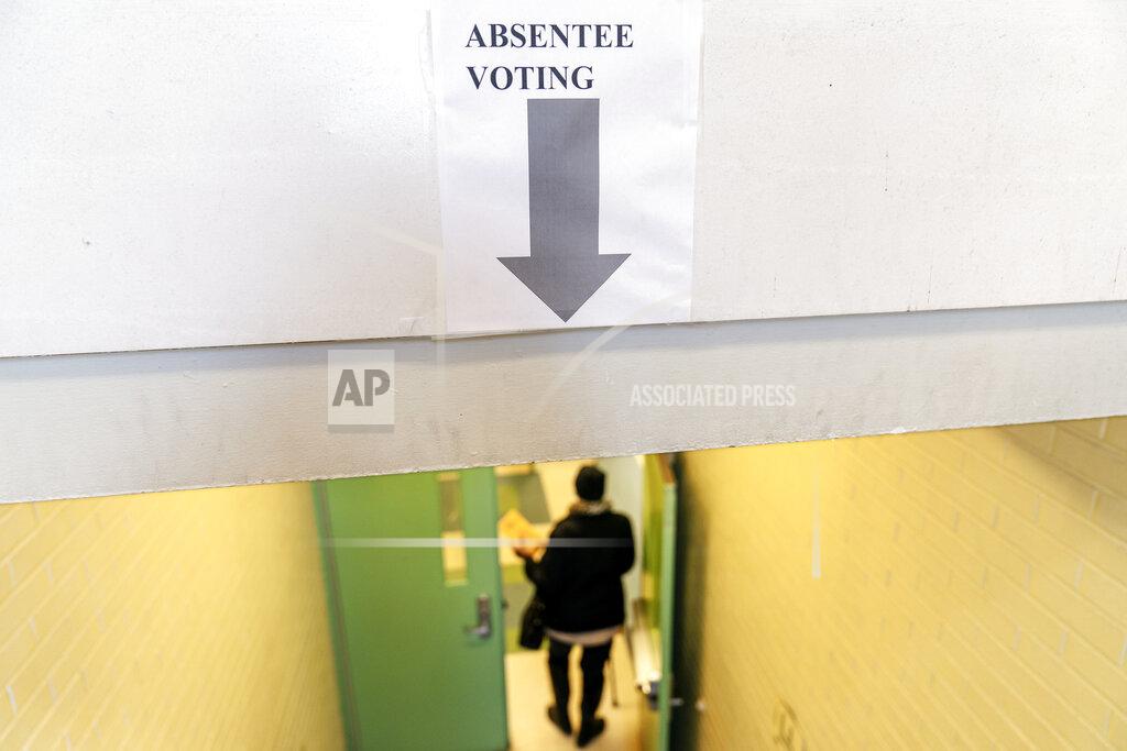 A voters enters to fill out a ballot on the last day of early absentee voting before tomorrow's general election at the Northwest Activities Center in Detroit, Monday, Nov. 2, 2020. Down to the wire with the threat of court battles looming, supporters of former Vice President Joe Biden scrambled Monday to rally swing-state voters to drop off ballots, visit precincts in person and ensure their votes are counted. (AP Photo/David Goldman)