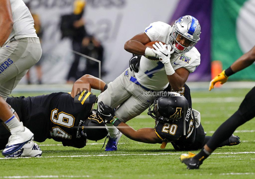 Gerald Herbert Middle Tennessee running back Terelle West (1) is tackled by Appalachian State defensive lineman Josh Houser (94) and linebacker Noel Cook (20) in the second half of the New Orleans Bowl NCAA college football game in New Orleans, Saturday, Dec. 15, 2018. Appalachian State won 45-13. (AP Photo/Gerald Herbert)