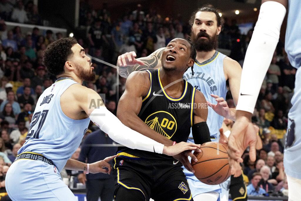 Karen Pulfer Focht Golden State Warriors' Jonathan Kuminga (00) goes up for a basket as Memphis Grizzlies' Tyus Jones (21) defends in the first half of Game 5 of an NBA basketball second-round playoff series Wednesday, May 11, 2022, in Memphis, Tenn. (AP Photo/Karen Pulfer Focht)