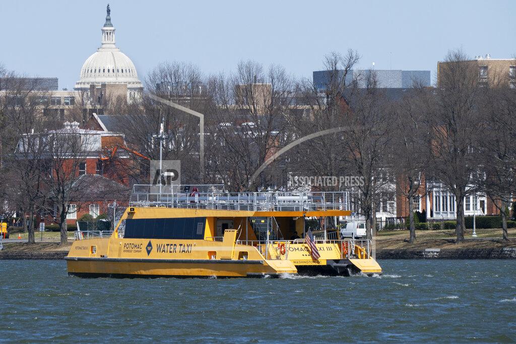 Jacquelyn Martin In this Friday March 19, 2021, photo a water taxi passes in the waterway next to Fort McNair, with the Capitol seen in the background in Washington. Iran has made threats against Fort McNair, a U.S. army base in Washington DC, and against the Army’s vice chief of staff, according to two senior U.S. intelligence officials, who spoke on condition of anonymity to discuss national security matters. The threats are one reason the Army has been pushing for more security around the base, which sits alongside the bustling Waterfront district of Washington DC. (AP Photo/Jacquelyn Martin)