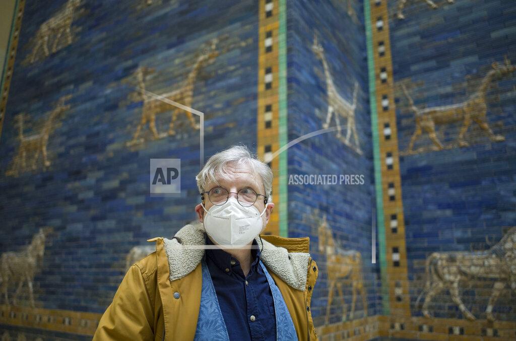 Markus Schreiber Metal restoration specialist Gert Jendritzki stands in front of Babylon's Ishtar Gate at the eve of the reopening of the Museum of the Ancient East in Berlin, Germany, Monday, March 15, 2021. Museums throughout Germany closed at the beginning of November as coronavirus cases increased. Under new regulations, some of the collections on Berlin's Museum Island, one of the city's cultural highlights and a UNESCO World Heritage site, are now allowed to re-open to visitors. (AP Photo/Markus Schreiber)