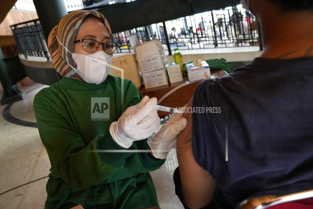 Dita Alangkara A health worker gives a shot of the Sinovac COVID-19 vaccine to a man during a mass vaccination in Jakarta, Indonesia, Monday, June 21, 2021. Indonesia's president ordered authorities to speed up the country's vaccination campaign as the World Health Organization warned of the need to increase social restrictions in the country amid a fresh surge of coronavirus infections caused by worrisome variants. (AP Photo/Dita Alangkara)