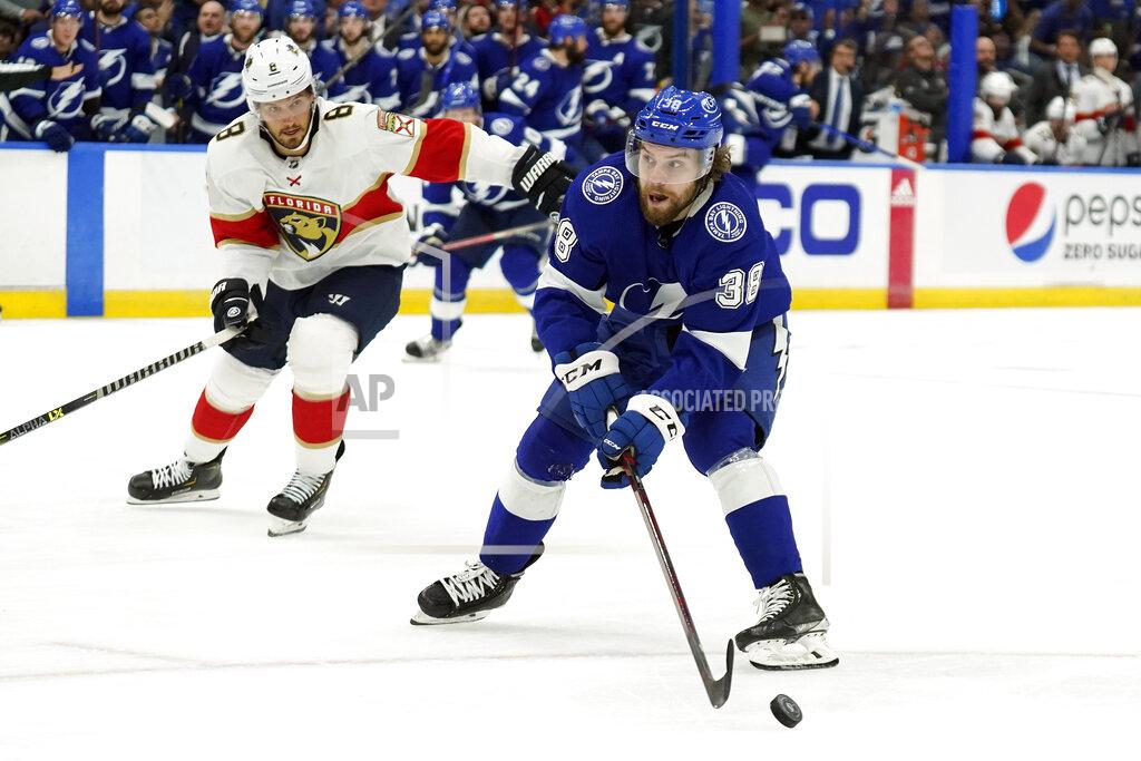Chris O'MEara Tampa Bay Lightning left wing Brandon Hagel (38) gets off a shot after getting around Florida Panthers defenseman Ben Chiarot (8) during the second period in Game 4 of an NHL hockey second-round playoff series Monday, May 23, 2022, in Tampa, Fla. (AP Photo/Chris O'Meara)