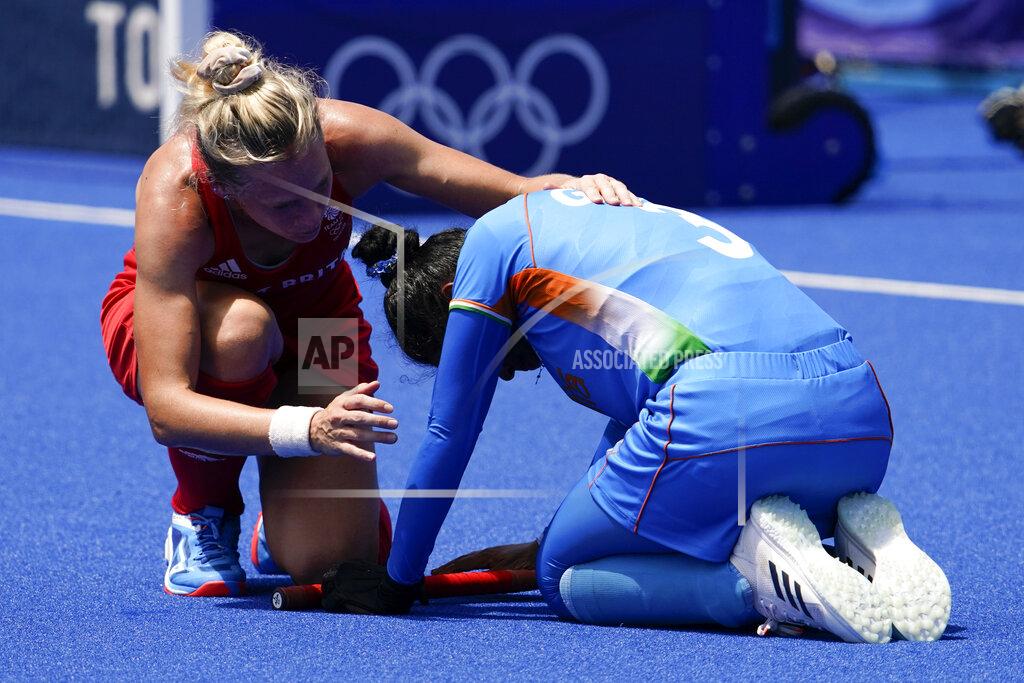 John Locher Britain's Leah Julia Wilkinson, left, comforts India's Deep Grace Ekka after Britain won their women's field hockey bronze medal match at the 2020 Summer Olympics, Friday, Aug. 6, 2021, in Tokyo, Japan. Britain won 4-3. (AP Photo/John Locher)