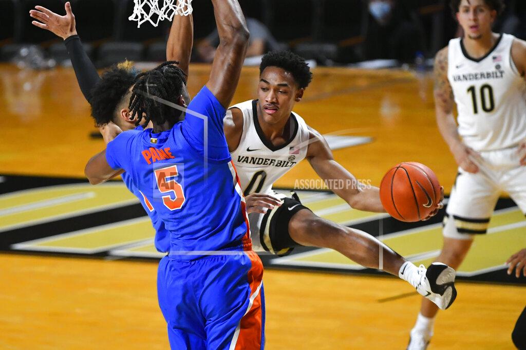 John Amis Vanderbilt guard Tyrin Lawrence looks to pass the ball as Florida forward Omar Payne (5) defends during the first half of an NCAA college basketball game Wednesday, Dec. 30, 2020, in Nashville, Tenn. (AP Photo/John Amis)