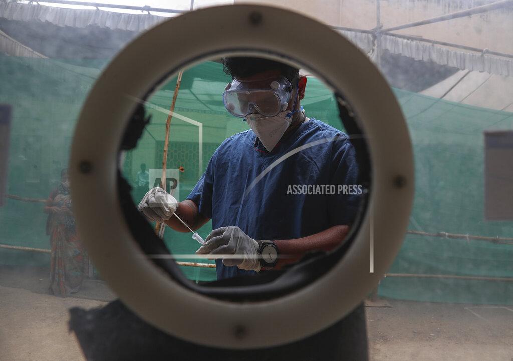 Mahesh Kumar A FILE - In this April 12, 2021, file photo, health worker collects nasal swab samples at a COVID-19 testing center in Hyderabad, India. The World Health Organization said Monday, May 10, that a worrisome variant was first detected in India may spread more easily. Scientists are still trying to figure out if it resulted in the terrifying surge of infections in the nation, and looking to see if this could this happen elsewhere. (AP Photo/Mahesh Kumar A., File)