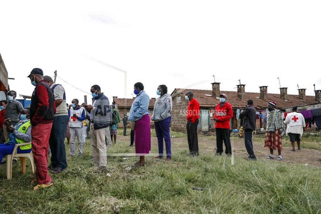 Brian Inganga Kenyans queue to receive the AstraZeneca coronavirus vaccine donated by Britain, at the Makongeni Estate in Nairobi, Kenya Saturday, Aug. 14, 2021. In late June, the international system for sharing coronavirus vaccines sent about 530,000 doses to Britain – more than double the amount sent that month to the entire continent of Africa. It was the latest example of how a system that was supposed to guarantee low and middle-income countries vaccines is failing, leaving them at the mercy of haphazard donations from rich countries. (AP Photo/Brian Inganga)
