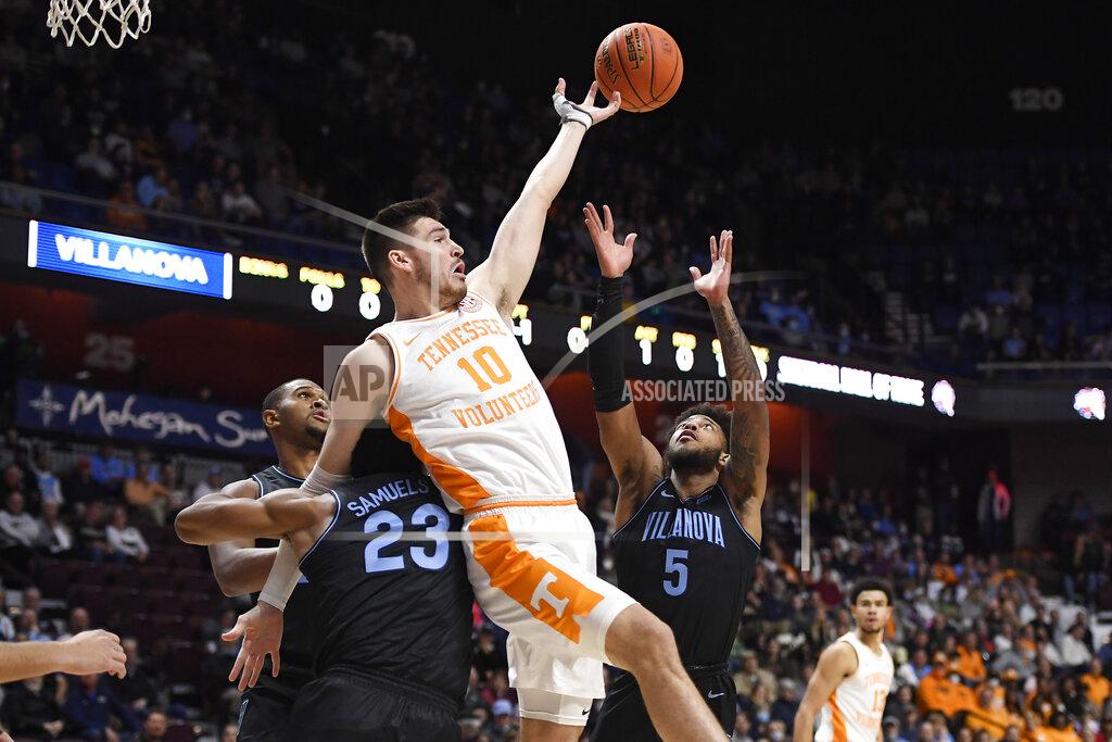 Jessica Hill Tennessee's John Fulkerson (10) tangles with Villanova's Jermaine Samuels (23) while reaching for a rebound with Villanova's Justin Moore (5) in the first half of an NCAA college basketball game, Saturday, Nov. 20, 2021, in Uncasville, Conn. (AP Photo/Jessica Hill)