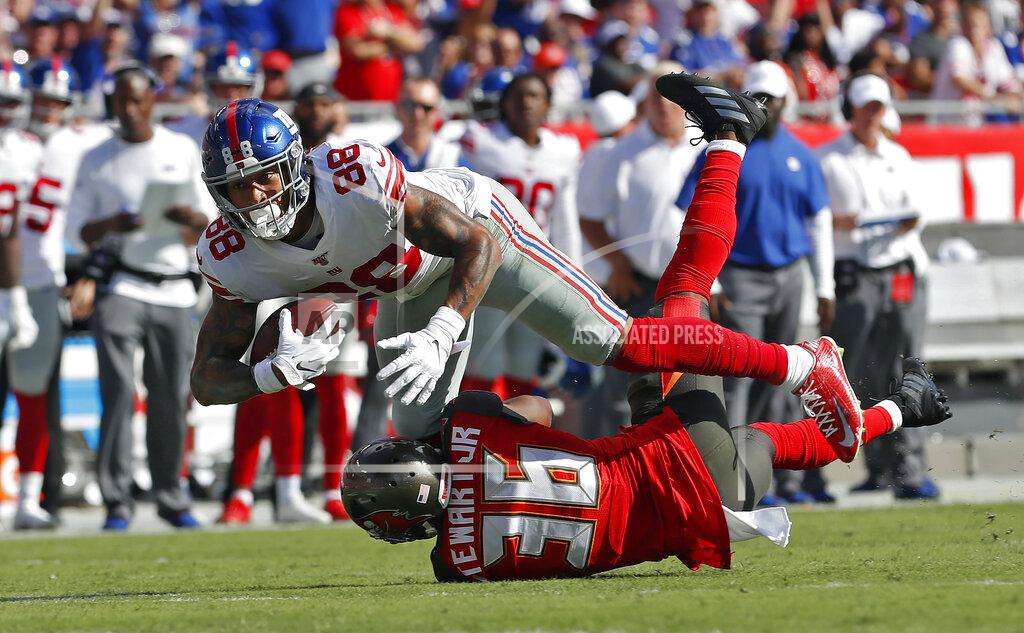 Mark Lomoglio New York Giants tight end Evan Engram (88) runs over Tampa Bay Buccaneers cornerback M.J. Stewart after a reception during the first half of an NFL football game Sunday, Sept. 22, 2019, in Tampa, Fla. (AP Photo/Mark LoMoglio)