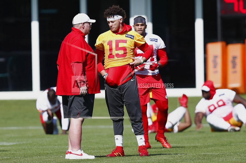 Kansas City Chiefs quarterback Patrick Mahomes (15) talks with head coach Andy Reid during practice on Wednesday, Jan. 29, 2020, in Davie, Fla., for the NFL Super Bowl 54 football game. (AP Photo/Brynn Anderson)