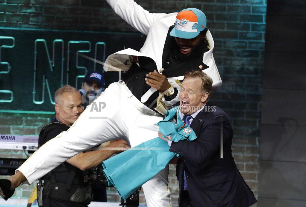 Steve Helber FILE - In this April 25, 2019, file photo, Clemson defensive tackle Christian Wilkins moves into NFL Commissioner Roger Goodell after the Miami Dolphins selected Wilkins in the first round at the NFL football draft in Nashville, Tenn. NFL vice president Troy Vincent has sent a letter to several prospects inviting them to participate “live” in the NFL draft in three weeks. In recent drafts, first-round selections were announced by Commissioner Goodell. Then followed hugs involving players and Goodell — some of them comical — and photo sessions with the players wearing team ball caps or even showing off team jerseys. This year, with all public events at the planned site of Las Vegas canceled and the draft set to proceed remotely, players will likely be at their homes when their names are called. (AP Photo/Steve Helber, File)