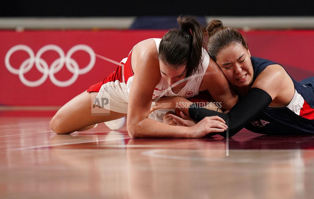 Charlie Neibergall Canada's Bridget Carleton (6), left, and South Korea's Ji Su Park (19) fight for the loose ball during women's basketball preliminary round game at the 2020 Summer Olympics, Thursday, July 29, 2021, in Saitama, Japan. (AP Photo/Charlie Neibergall)