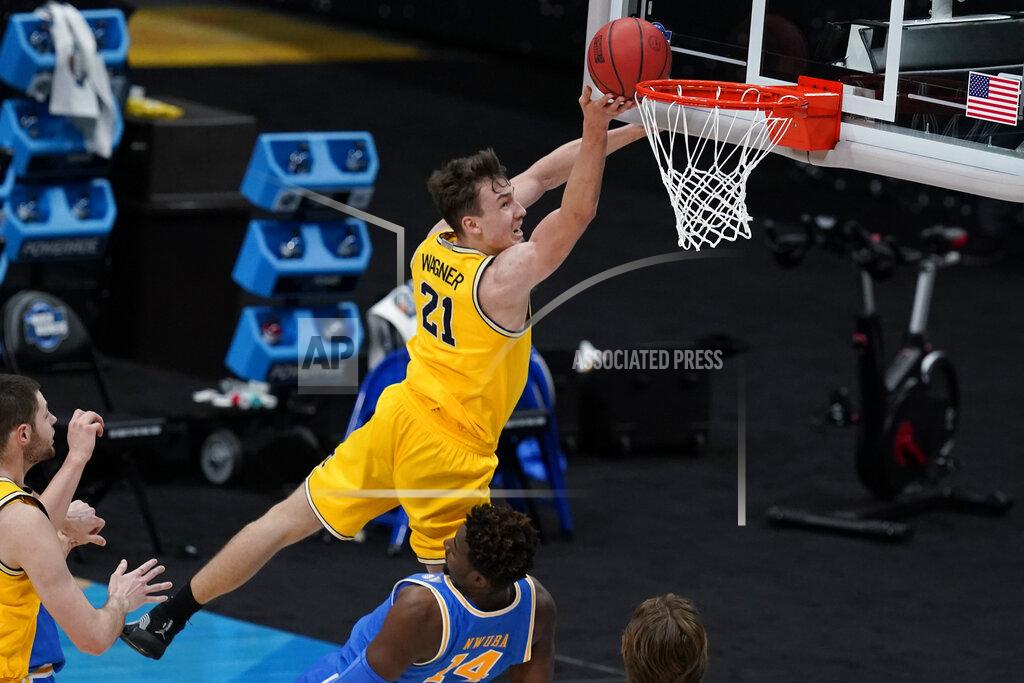Michael Conroy FILE - In this March 30, 2021, file photo, Michigan guard Franz Wagner (21) drives to the basket over UCLA forward Kenneth Nwuba (14) during the first half of an Elite 8 game in the NCAA men's college basketball tournament in Indianapolis. (AP Photo/Michael Conroy, File)