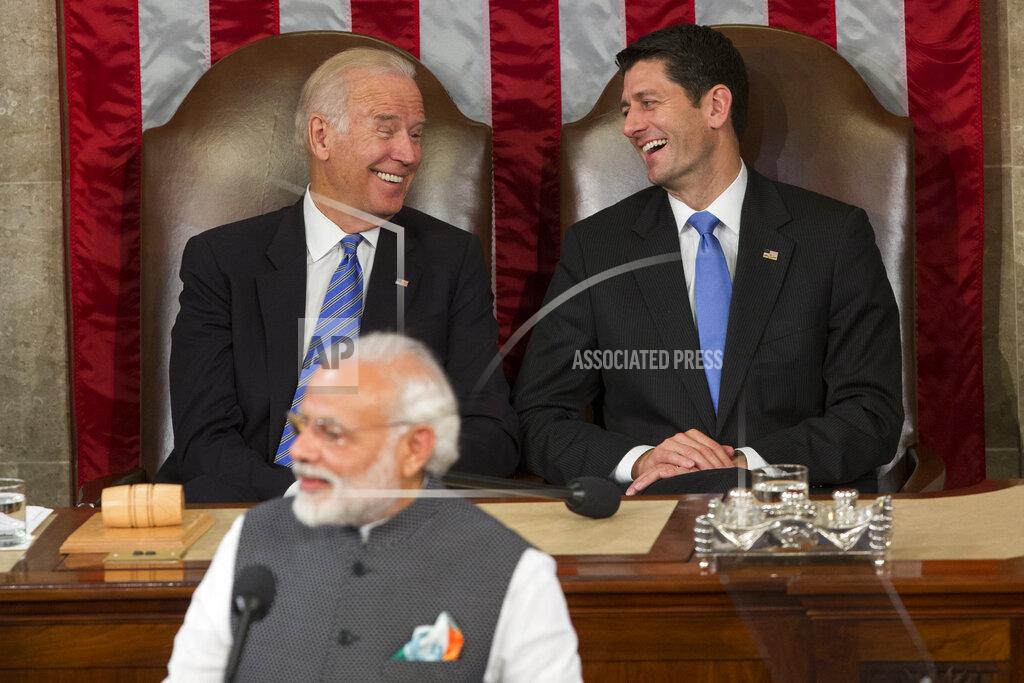 Evan Vucci FILE- In this June 8, 2016 file photo, then Vice President Joe Biden and then House Speaker Paul Ryan of Wis., laugh as Indian Prime Minister Narendra Modi addresses a joint meeting of Congress on Capitol Hill in Washington. As Americans celebrate or fume over the new U.S. president-elect, many in Asia are waking up to the reality of a Joe Biden administration with decidedly mixed feelings. Relief and hopes of economic and environmental revival jostle with needling anxiety and fears of inattention. Not much will change with the host of security and defense ties shared by India and the United States. But a Biden administration could mean a much closer look at India’s spotty recent human rights and religious freedom records, both of which were largely ignored by U.S. President Donald Trump. (AP Photo/Evan Vucci, File)