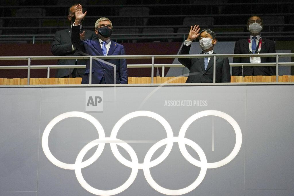 Natacha Pisarenko President of the IOC Thomas Bach, left, and Japan's Emperor Naruhito wave during the opening ceremony in the Olympic Stadium at the 2020 Summer Olympics, Friday, July 23, 2021, in Tokyo, Japan. (AP Photo/Natacha Pisarenko)