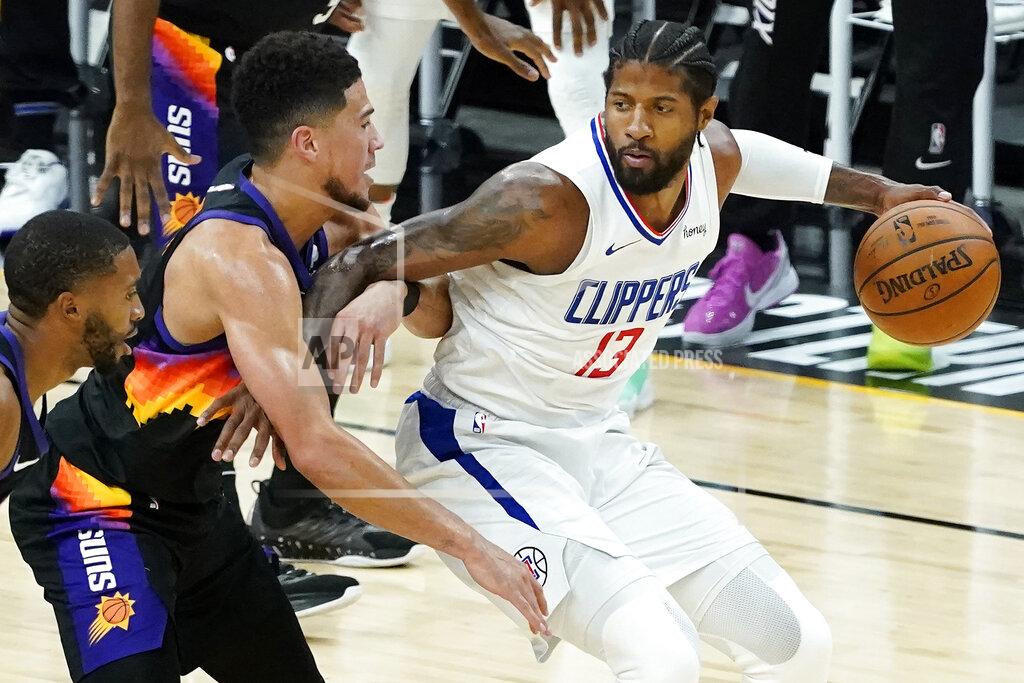 Matt York Los Angeles Clippers guard Paul George, right, is defended by Phoenix Suns guard Devin Booker during the first half of Game 2 of the NBA basketball Western Conference Finals, Tuesday, June 22, 2021, in Phoenix. (AP Photo/Matt York)
