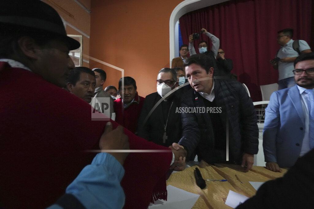 Dolores Ochoa Indigenous leader Leonidas Iza, left, shakes hands with Government Minister Francisco Jimenez after reaching an agreement with mediation by the church at the Episcopal Conference headquarters in Quito, Ecuador, Thursday, June 30, 2022. Ecuador's government and the country's main Indigenous group reached an agreement to end 18 days of often-violent strikes that had virtually paralyzed the country. At center is Monsignor Alfredo Espinoza. (AP Photo/Dolores Ochoa)