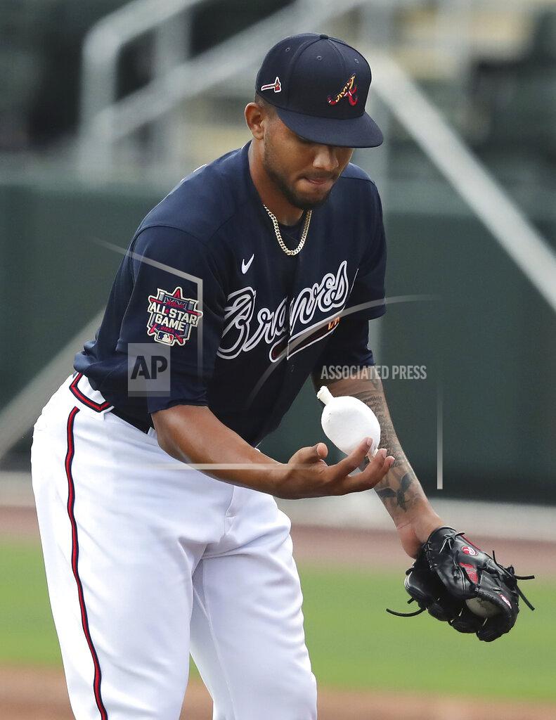 Curtis Compton Atlanta Braves pitcher Huascar Ynoa powders his throwing hand with a rosin bag while throwing live batting practice during baseball spring training, Wednesday, Feb. 24, 2021, in North Port, Fla. (Curtis Compton/Atlanta Journal-Constitution via AP)