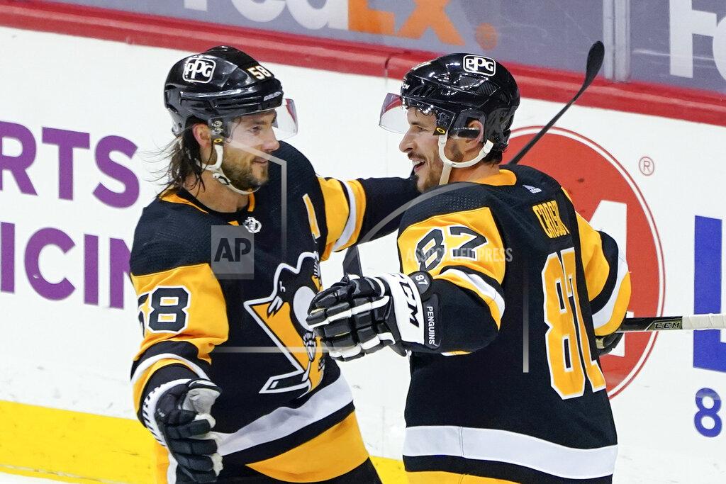 Keith Srakocic FILE - In this March 15, 2021, file photo, Pittsburgh Penguins' Sidney Crosby (87) celebrates with Kris Letang (58) after scoring against the Boston Bruins during the first period of an NHL hockey game in Pittsburgh. The Penguins and Islanders meet in Game 1 of their opening-round series on Sunday. The Islanders swept Pittsburgh in the first round of the playoffs in 2019. (AP Photo/Keith Srakocic)