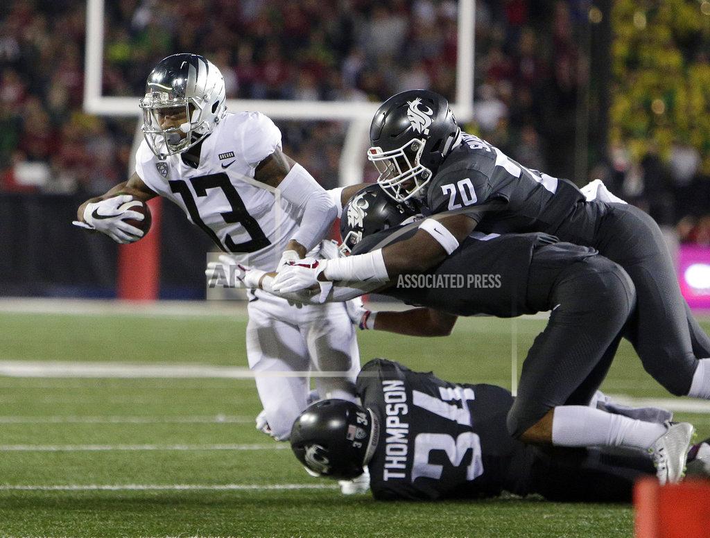 Young Kwak Washington State safety Jalen Thompson (34), linebacker Dominick Silvels (20) and cornerback Darrien Molton tackle Oregon wide receiver Dillon Mitchell (13) during the second half of an NCAA college football game in Pullman, Wash., Saturday, Oct. 20, 2018. Washington State won 34-20. (AP Photo/Young Kwak)