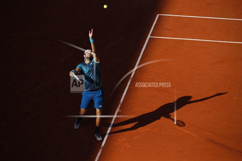 Christophe Ena Italy's Matteo Berrettini serves against Germany's Daniel Altmaier in the third round match of the French Open tennis tournament at the Roland Garros stadium in Paris, France, Saturday, Oct. 3, 2020. (AP Photo/Christophe Ena)