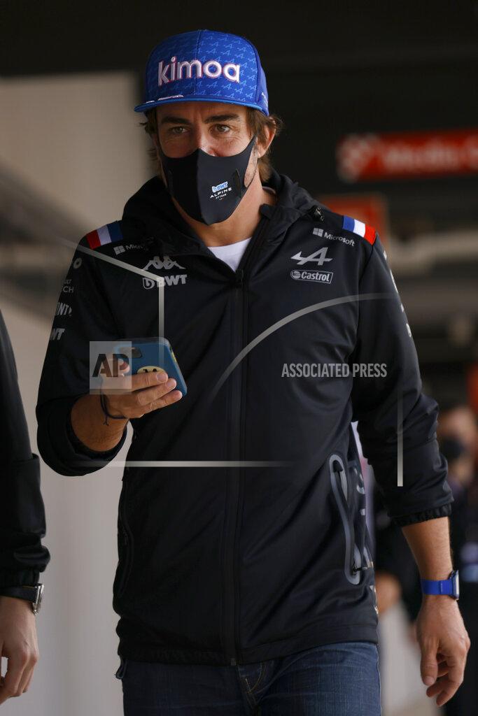 Joan Monfort Alpine driver Fernando Alonso of Spain walks through a corridor during a Formula One pre-season testing session at the Catalunya racetrack in Montmelo, just outside of Barcelona, Spain, Thursday, Feb. 24, 2022. (AP Photo/Joan Monfort)