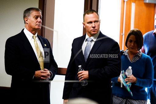 FILE - In this Oct. 24, 2019, file photo, suspended Greenville Sheriff Will Lewis, center, enters the courtroom with his wife, Amy, in Greenville, S.C. The former sheriff in South Carolina reported to prison Wednesday, Oct. 13, 2021, to serve a one-year sentence for using his power and office to pressure a personal assistant to have sex with him. The South Carolina Supreme Court refused to reconsider its August decision upholding ex-Greenville County Sheriff Will Lewis' 2019 conviction meaning Lewis ran out of appeals. (Josh Morgan/The Greenville News via AP, Pool, File)