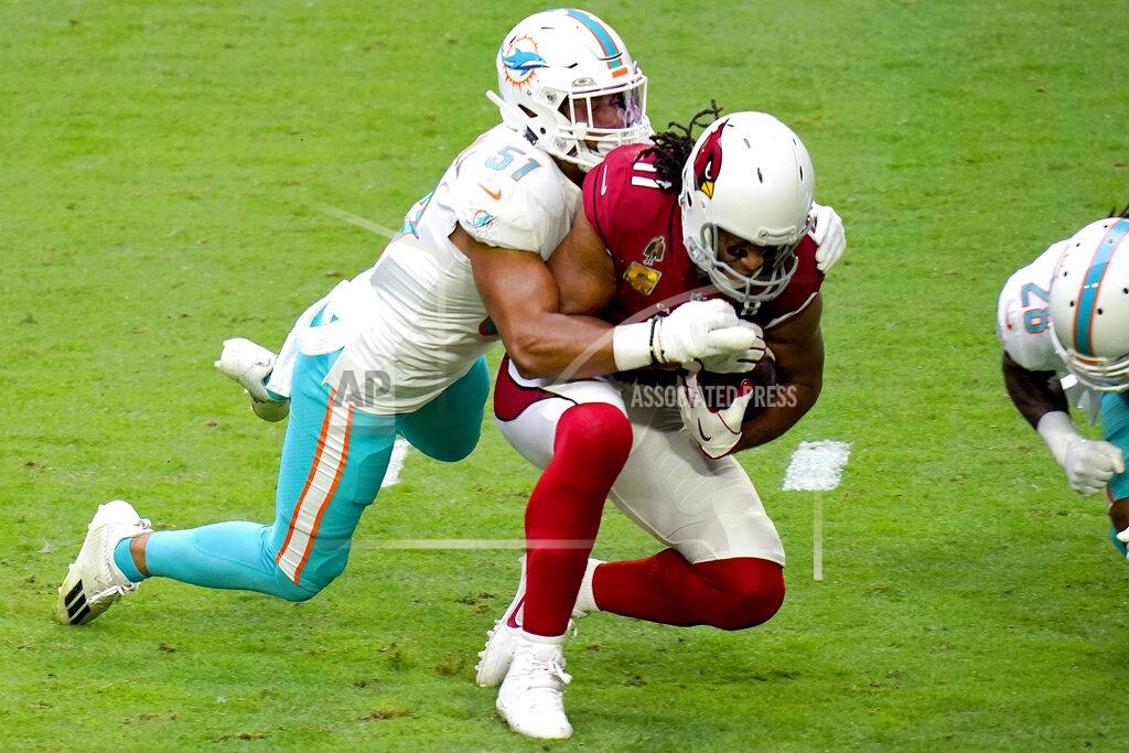 Ross D. Franklin Arizona Cardinals wide receiver Larry Fitzgerald (11) makes the catch as Miami Dolphins outside linebacker Kamu Grugier-Hill (51) makes the tackle during the first half of an NFL football game, Sunday, Nov. 8, 2020, in Glendale, Ariz. (AP Photo/Ross D. Franklin)