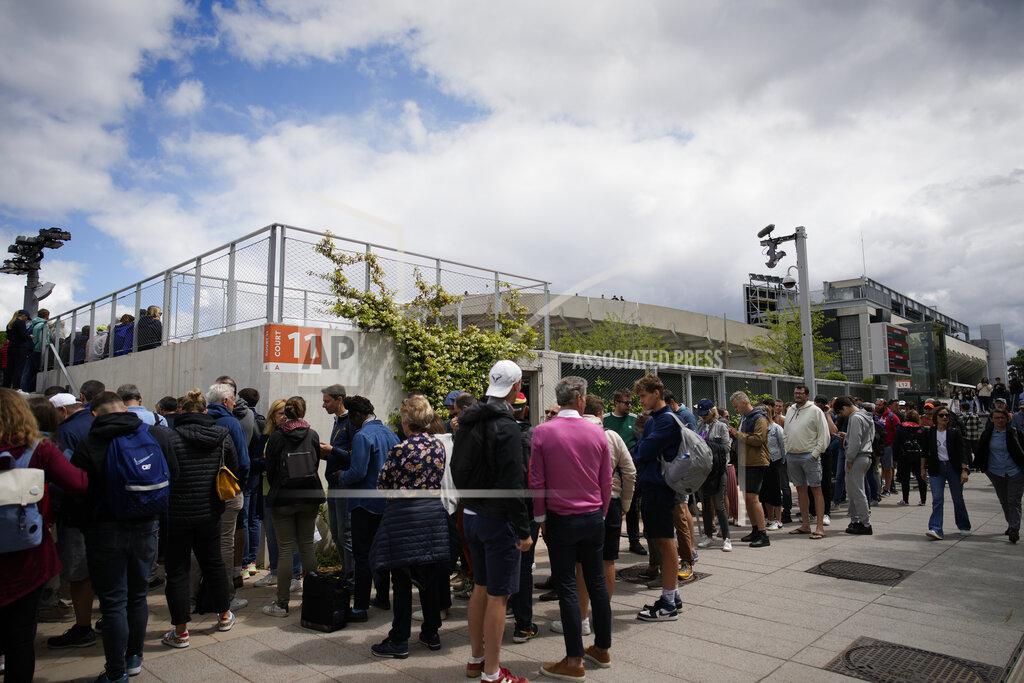 Christophe Ena Spectators queue to enter courts during first round matches at the French Open tennis tournament in Roland Garros stadium in Paris, France, Tuesday, May 24, 2022. (AP Photo/Christophe Ena)