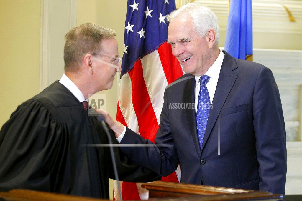 Bryan Terry John O'Connor, right, talks with Oklahoma Supreme Court Justice M. John Kane IV after being sworn in as Oklahoma's new attorney general at the state Capitol in Oklahoma City, Friday, July 23, 2021. Gov. Kevin Stitt named 66-year-old O'Connor to the post on Friday after a two-month search. (Bryan Terry/The Oklahoman via AP)