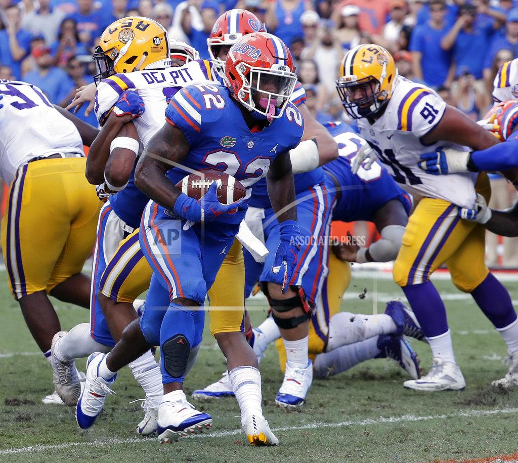 John Raoux Florida running back Lamical Perine (22) runs past the LSU defense for a 1-yard touchdown during the first half of an NCAA college football game, Saturday, Oct. 6, 2018, in Gainesville, Fla. (AP Photo/John Raoux)