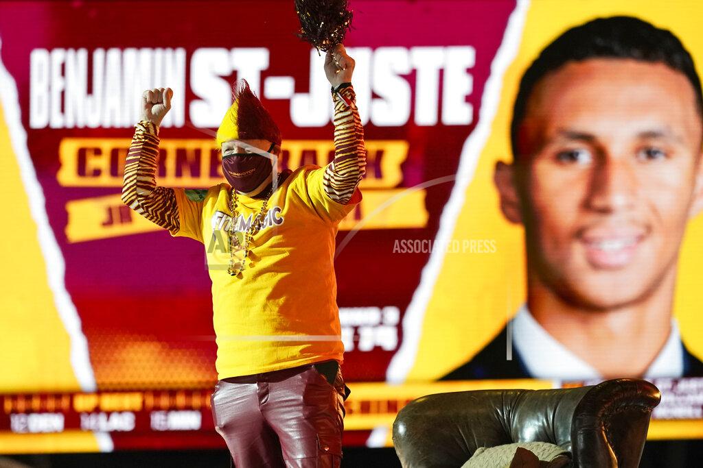 A Washington Football Team fan reacts after Washington picked Minnesota cornerback Benjamin St. Juste, during the third round of the NFL football draft, Friday, April 30, 2021, in Cleveland. (AP Photo/Tony Dejak)