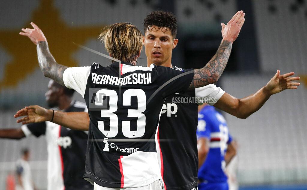 Antonio Calanni Juventus' Federico Bernardeschi, left, is congratulated by teammate Cristiano Ronaldo after scoring his team's second goal during the Serie A soccer match between Juventus and Sampdoria at the Allianz stadium in Turin, Italy, Sunday, July 26, 2020. (AP Photo/Antonio Calanni)