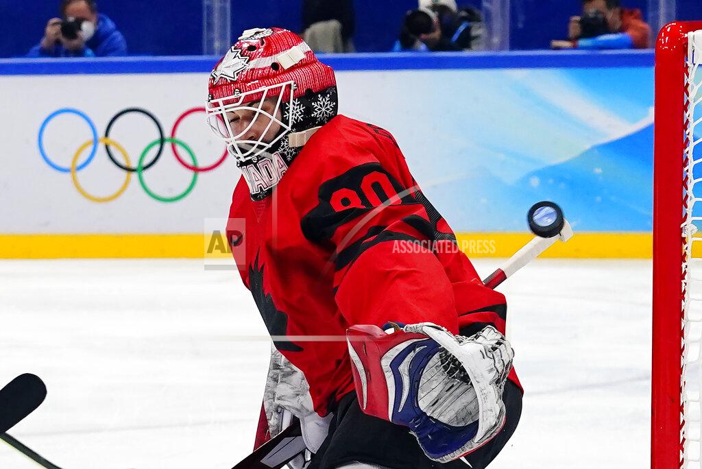 Canada goalkeeper Eddie Pasquale reaches for a shot by United States' Andy Miele that got past Pasquale for a goal during a preliminary round men's hockey game at the 2022 Winter Olympics, Saturday, Feb. 12, 2022, in Beijing. (AP Photo/Matt Slocum)