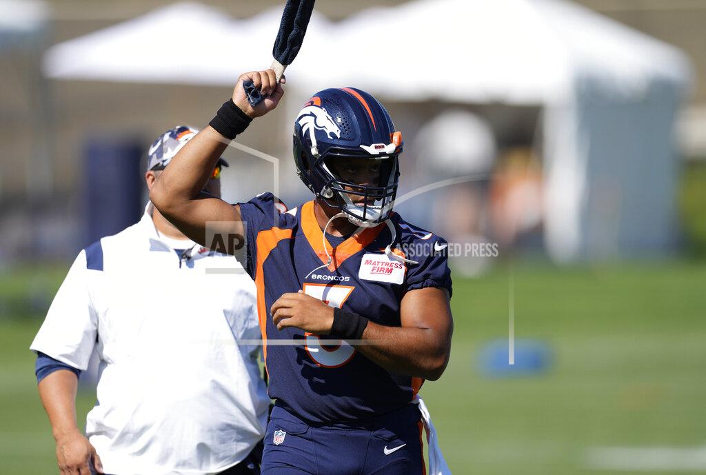 David Zalubowski Denver Broncos quarterback Russell Wilson warms up during the opening session of the NFL football team's training camp Wednesday, July 27, 2022, in Centennial, Colo. (AP Photo/David Zalubowski)