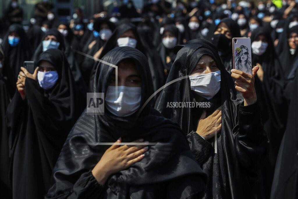 Ebrahim Noroozi People wearing protective face masks to help prevent spread of the coronavirus mourn during an annual ceremony commemorating Ashoura, the anniversary of the 7th century death of Imam Hussein, a grandson of Prophet Muhammad, and one of Shiite Islam's most beloved saints, who was killed in a battle in Karbala in present-day Iraq, at the Saleh shrine in northern Tehran, Iran, Sunday, Aug. 30, 2020. Authorities allowed limited mourning rituals, urged social distancing and made wearing masks mandatory. (AP Photo/Ebrahim Noroozi)