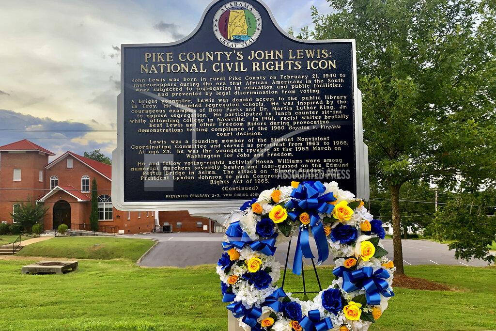 Kimberly Chandler In this July 21, 2020, photo, a sign outside the Troy Public Library in Troy, Ala., honors the late U.S. Rep. John Lewis. As a child in the 1940s and 1950s Lewis said he longed to go to the Pike County library but wasn't allowed because it was for whites only. Lewis applied for a library card knowing he would be denied in what he considered his first act of resistance to segregation. (AP Photo/Kimberly Chandler)