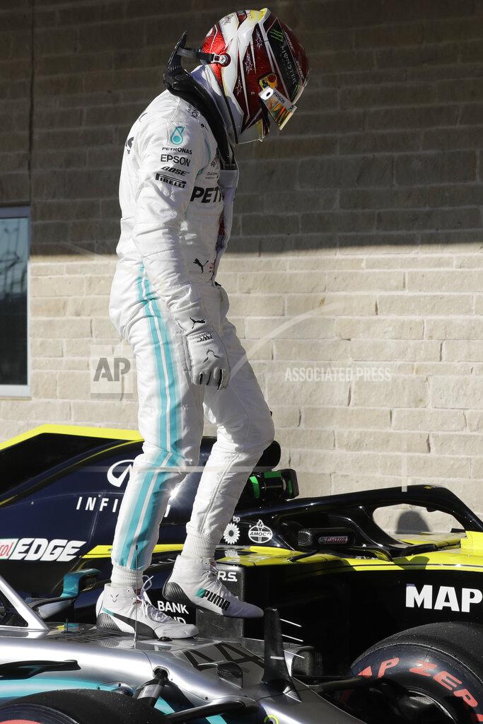 Darron Cummings Mercedes driver Lewis Hamilton, of Britain, get out of his car after the qualifying session for the Formula One U.S. Grand Prix auto race at the Circuit of the Americas, Saturday, Nov. 2, 2019, in Austin, Texas. (AP Photo/Darron Cummings)