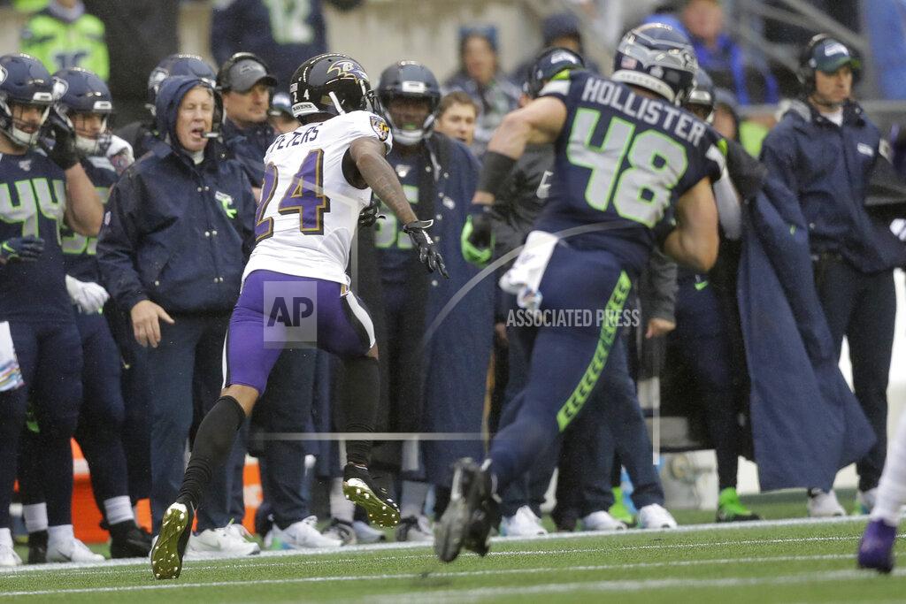 John Froschauer Baltimore Ravens cornerback Marcus Peters (24) runs for a touchdown as Seattle Seahawks tight end Jacob Hollister pursues after Peters intercepted a pass during the first half of an NFL football game, Sunday, Oct. 20, 2019, in Seattle. Peters ran for a touchdown on the play. (AP Photo/John Froschauer)