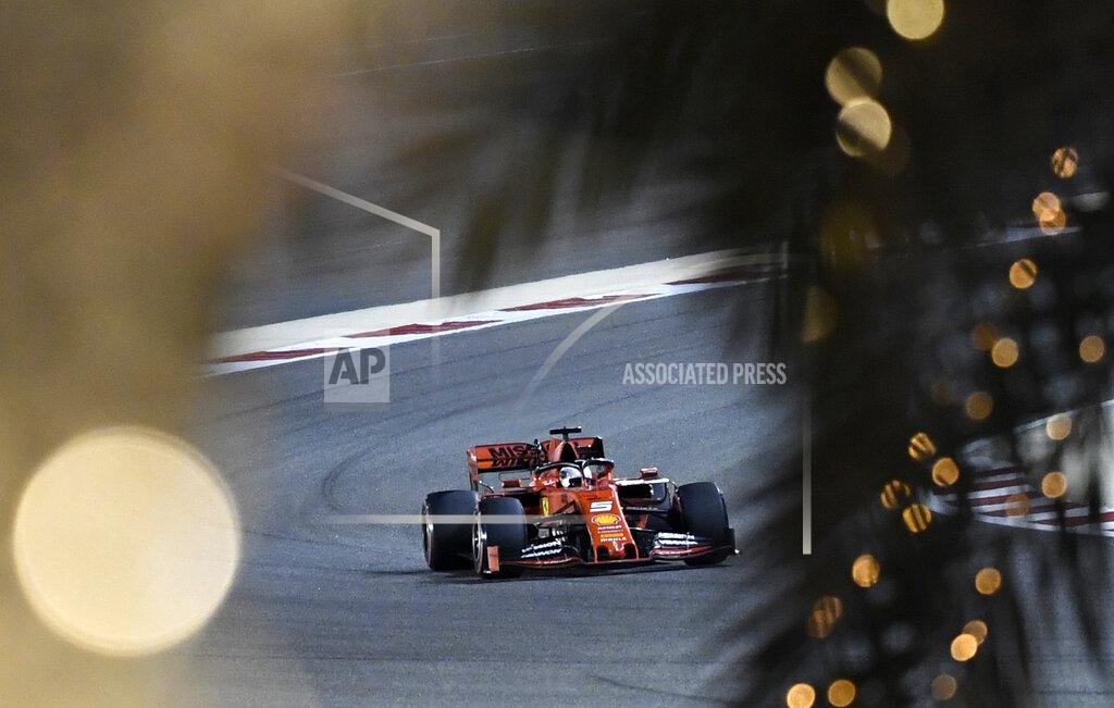 Hassan Ammar Ferrari driver Sebastian Vettel of Germany steers his car during the qualifying session at the Formula One Bahrain International Circuit in Sakhir, Bahrain, Saturday, March 30, 2019. The Bahrain Formula One Grand Prix will take place on Sunday. (AP Photo/Hassan Ammar)