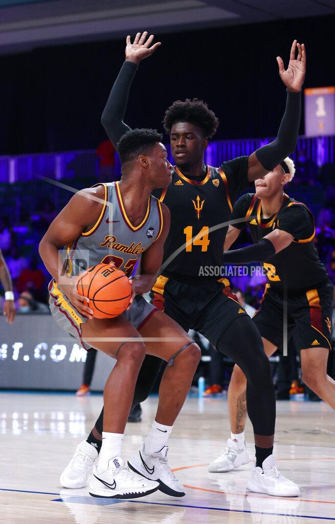 Tim Aylen In a photo provided by Bahamas Visual Services, Loyola Chicago forward Chris Knight (23) is defended by Arizona State's Enoch Boakye during an NCAA college basketball game at Paradise Island, Bahamas, Friday, Nov. 26, 2021. (Tim Aylen/Bahamas Visual Services via AP)